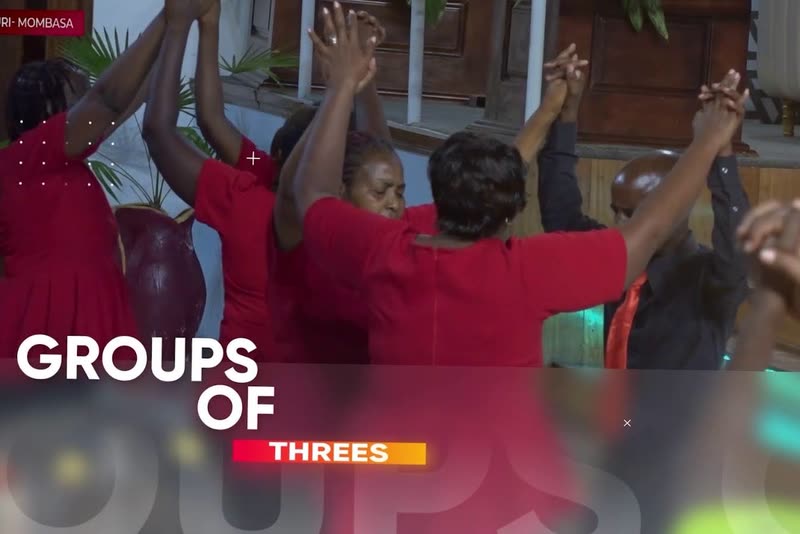 JCC members praying together with joined hands raised: Groups of Threes